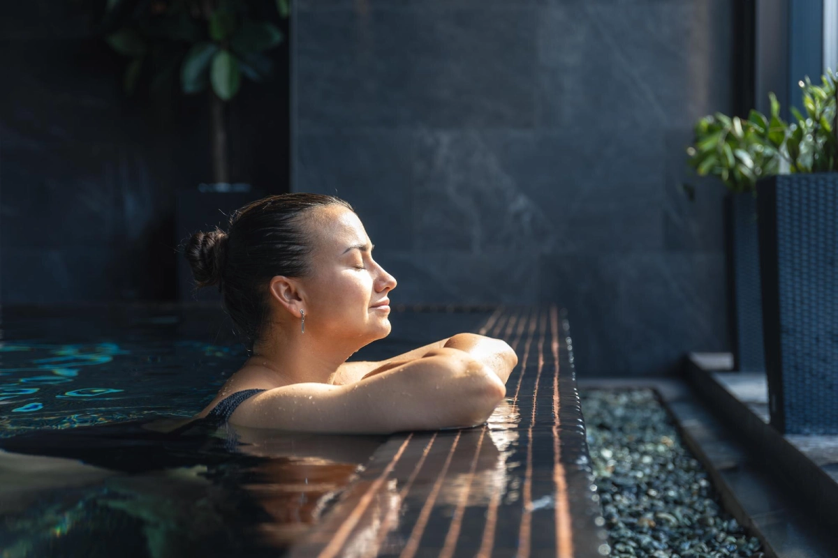 woman relaxing spa pool by window quiet mindful pause 169016 69297